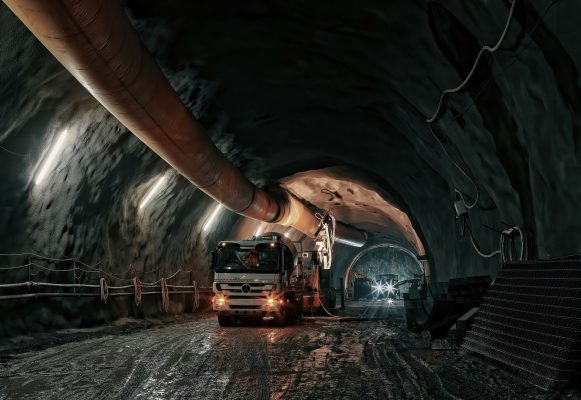 A mining vehicle drives through a tunnel that has IoT air quality sensors.