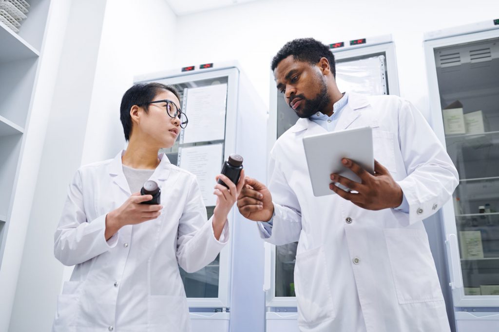 Two pharmacists discuss medications that were stored in an IoT enabled cooler.