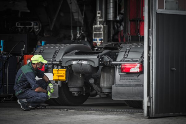 A service technician assesses a truck equipped with IoT technology.