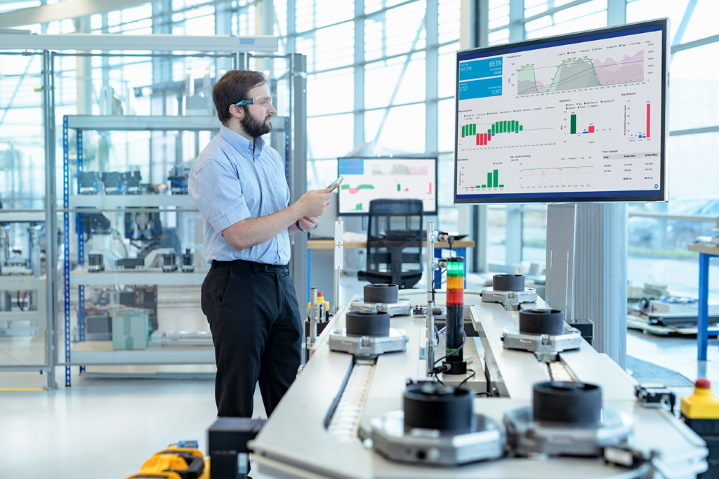 An engineer studies IoT generated remote monitoring data from his machinery.